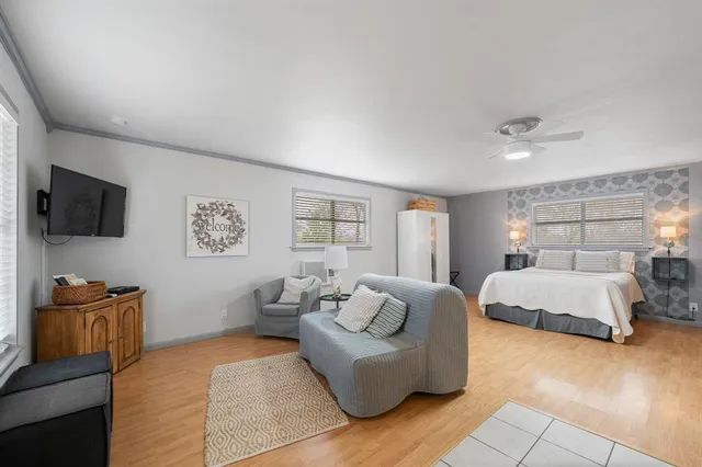 a bedroom with furniture and a flat screen tv