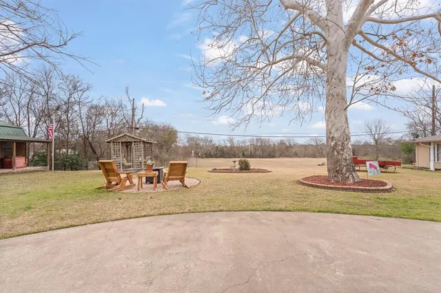a view of a park with table and chairs