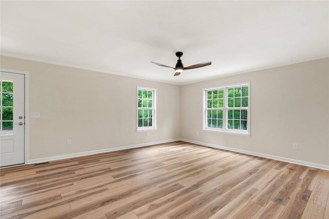 131 Lockaby Road Pelzer, SC 29669 - Photo 14 of 50 This bright room features beautiful flooring and large windows, creating an inviting and airy atmosphere.