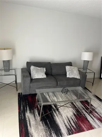 a living room with furniture and a lamp