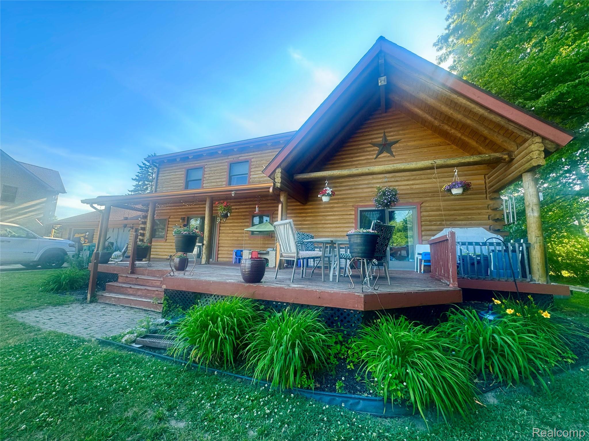 16501 Hannan Road Romulus, MI 48174 - Photo 3 of 20 Log cabin-style residence featuring a prominent gabled roofline and an expansive wooden deck