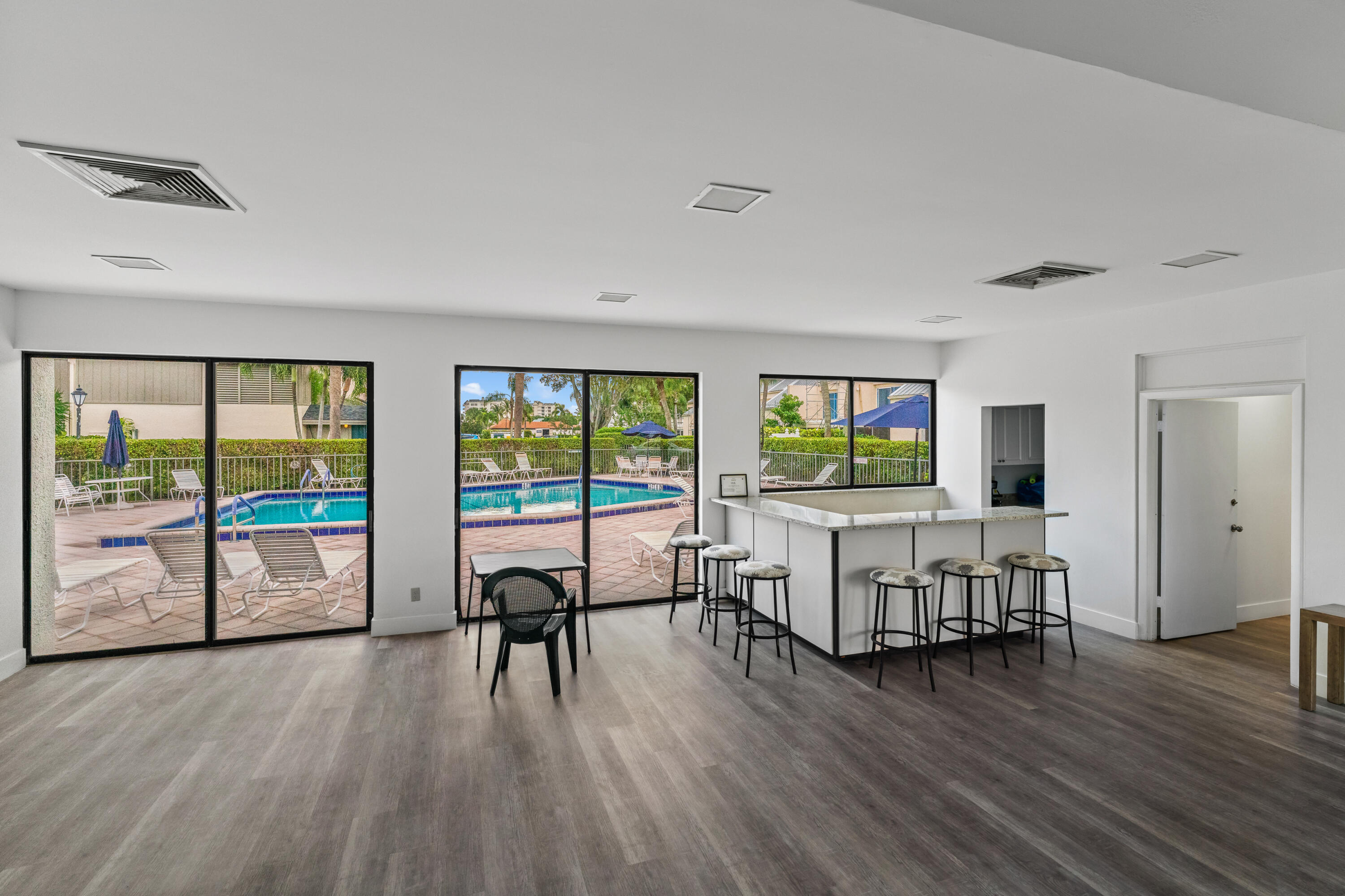 a living room with furniture and a flat screen tv with wooden floor