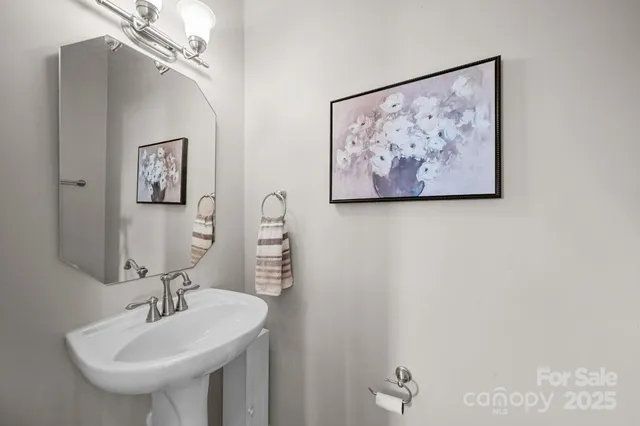 a bedroom with a bed chandelier and window