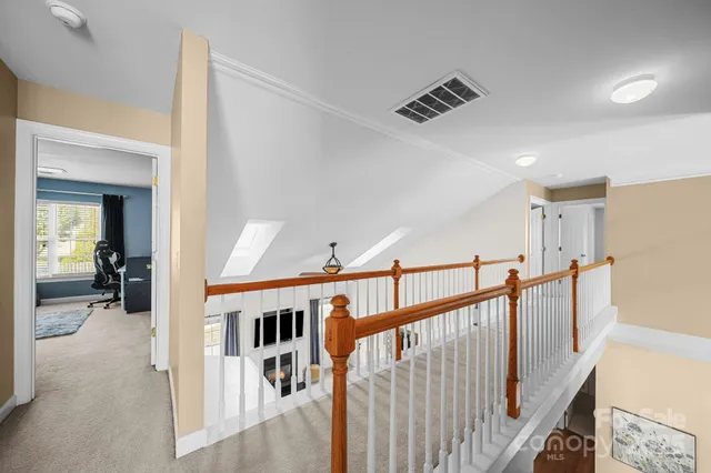 a living room with furniture a window and a flat screen tv