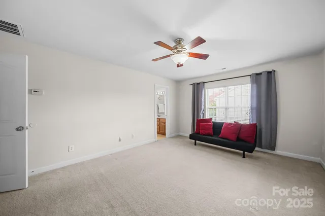 a front view of house with yard and trees in the background