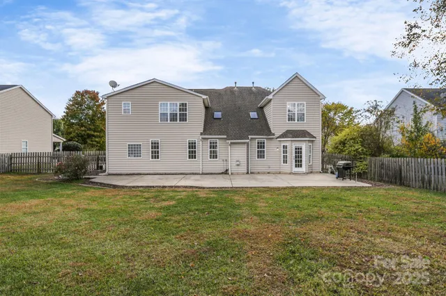 a view of a yard with a house in the background