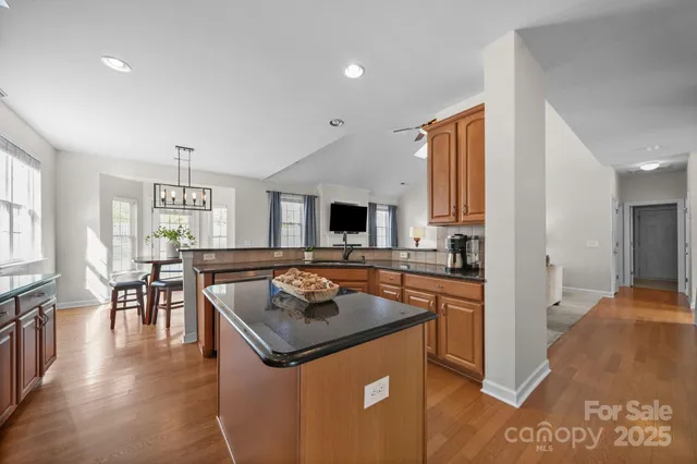 a kitchen with granite countertop stainless steel appliances a sink dishwasher a stove top oven a sink with granite countertops and cabinets