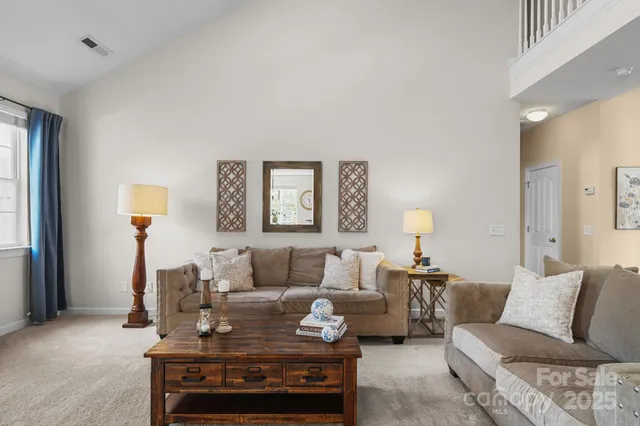 a living room with furniture and white walls