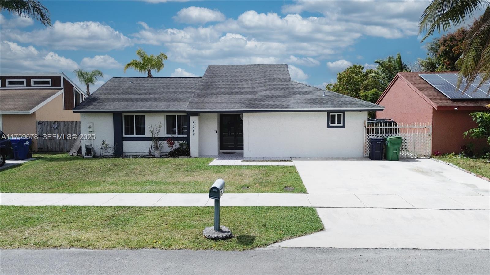 20520 Southwest 124th Place Miami, FL 33177 - Photo 1 of 34 a front view of a house with a garden