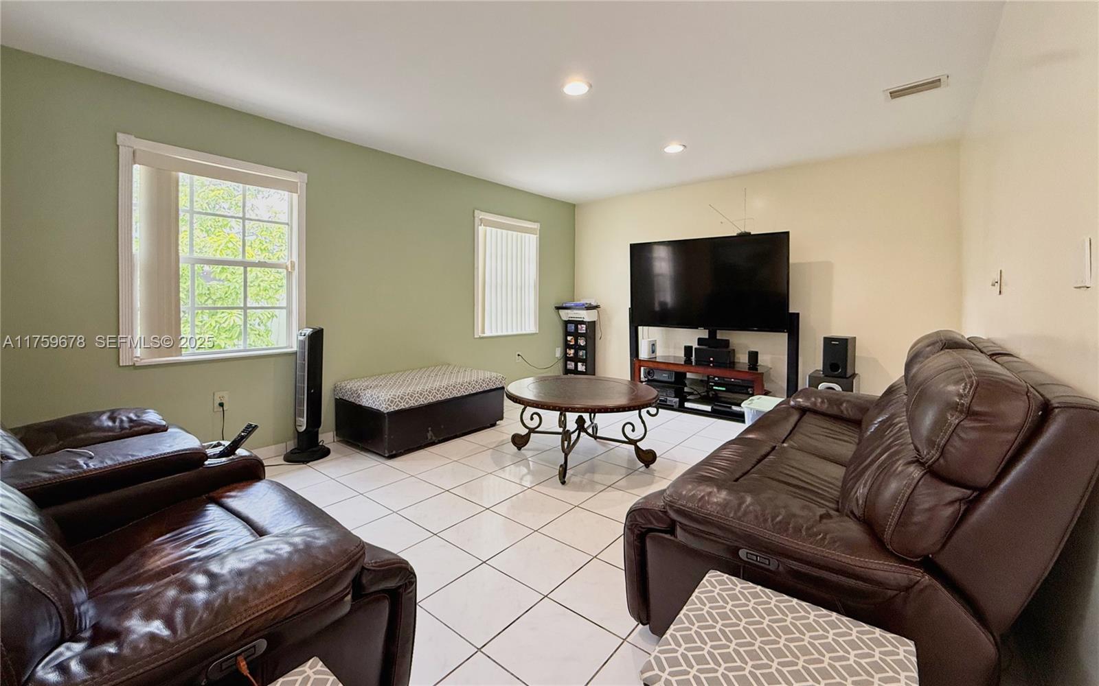 20520 Southwest 124th Place Miami, FL 33177 - Photo 11 of 34 a living room with furniture and a flat screen tv