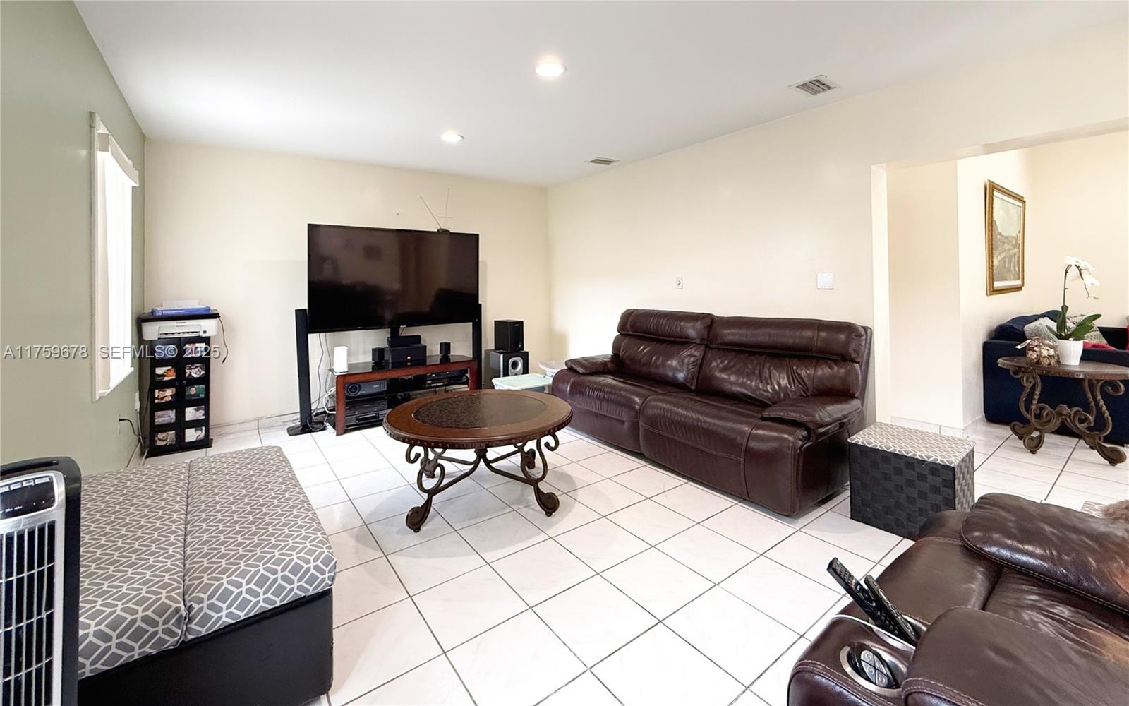 20520 Southwest 124th Place Miami, FL 33177 - Photo 12 of 34 a living room with furniture and a flat screen tv
