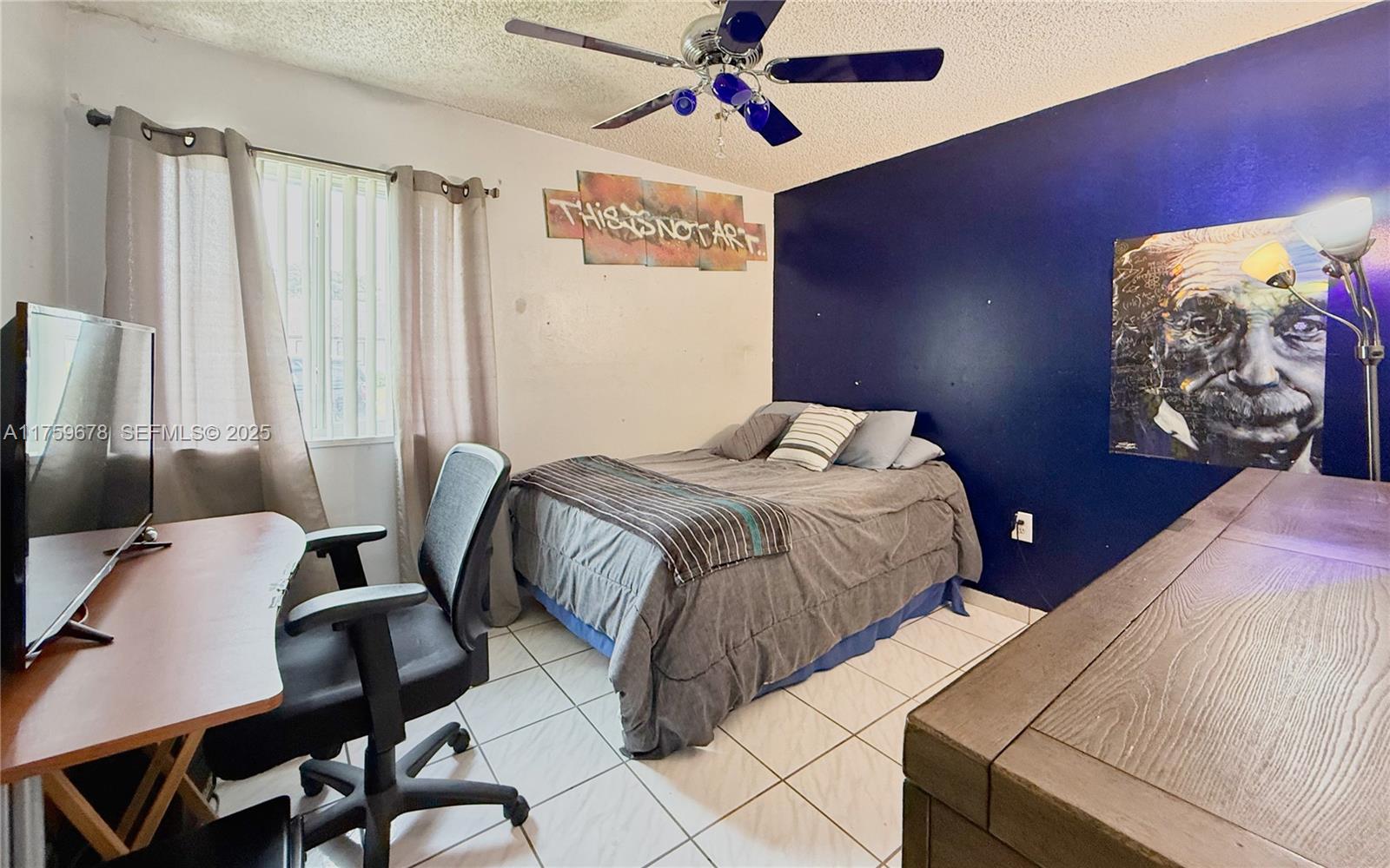 20520 Southwest 124th Place Miami, FL 33177 - Photo 16 of 34 a bedroom with a bed and a chandelier