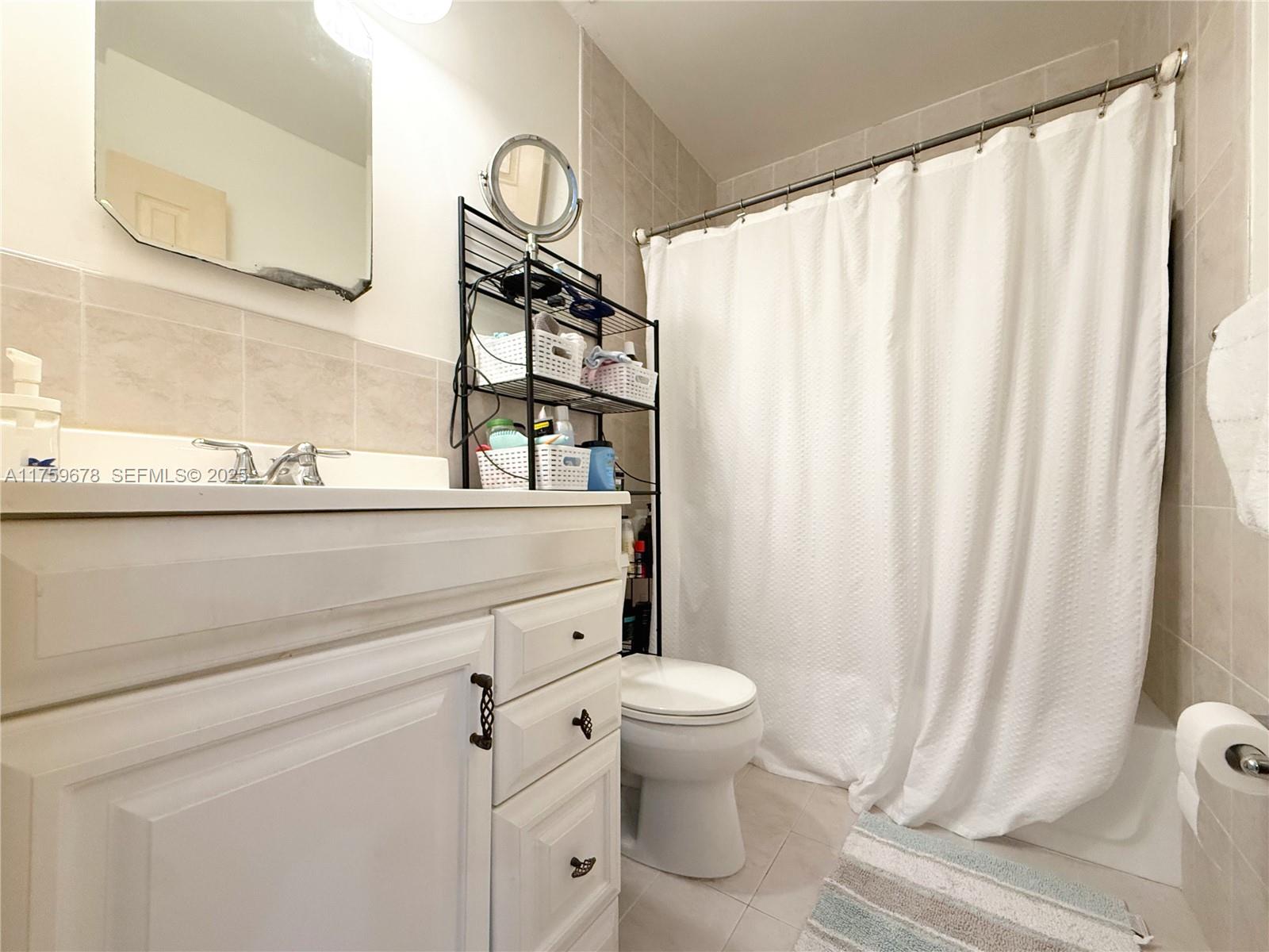 20520 Southwest 124th Place Miami, FL 33177 - Photo 18 of 34 a bathroom with a granite countertop sink toilet and mirror