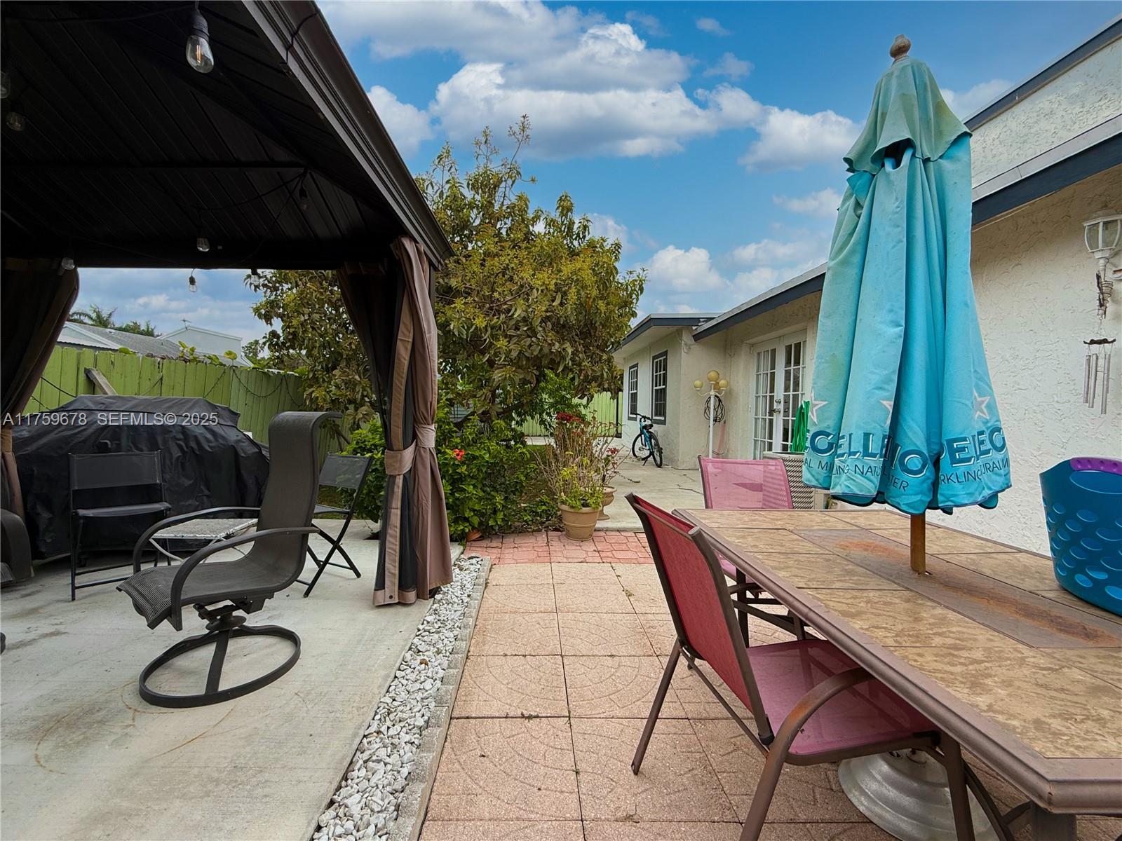 20520 Southwest 124th Place Miami, FL 33177 - Photo 25 of 34 a backyard of a house with seating space and trees