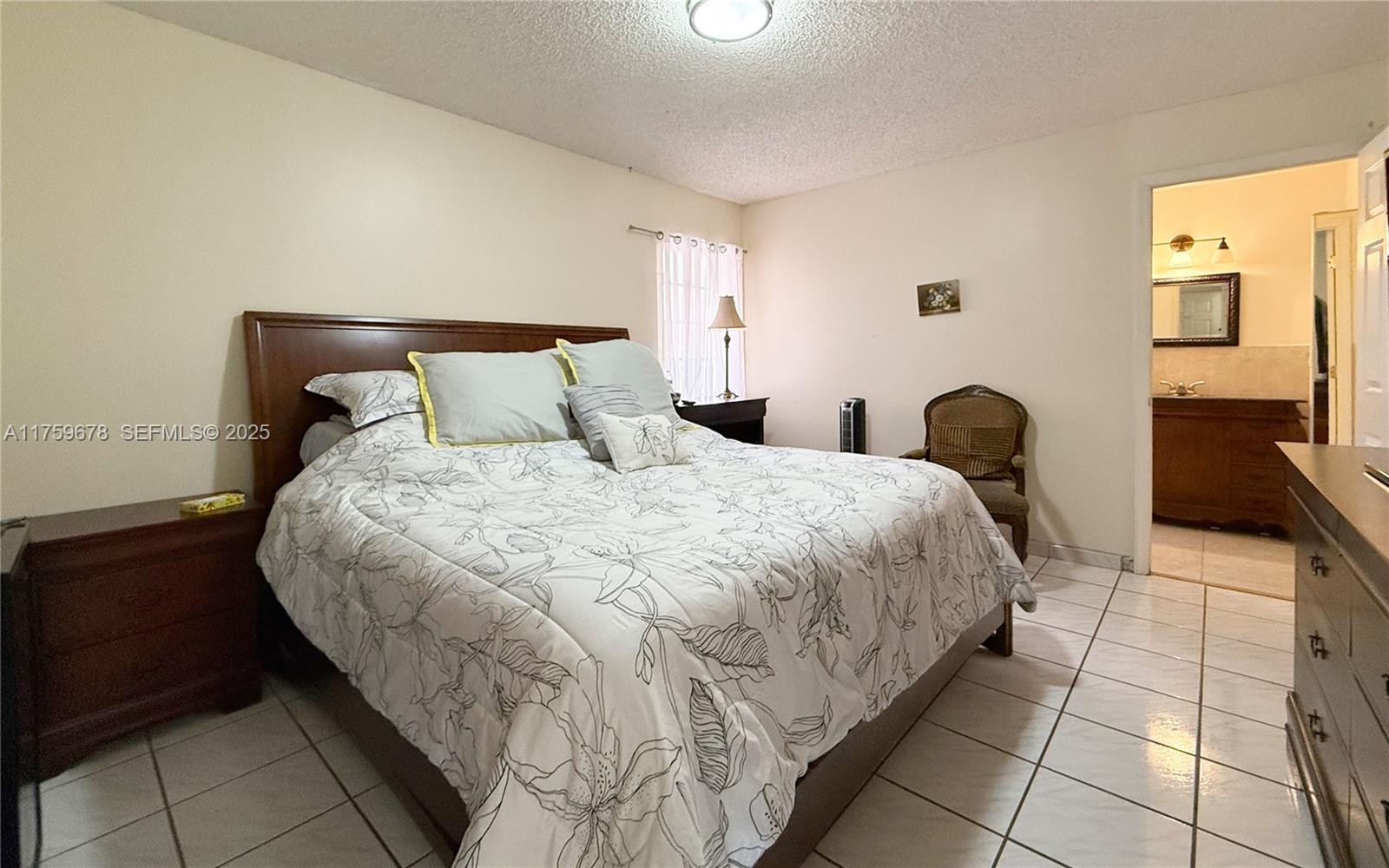 20520 Southwest 124th Place Miami, FL 33177 - Photo 6 of 34 a bedroom with a bed and a couch