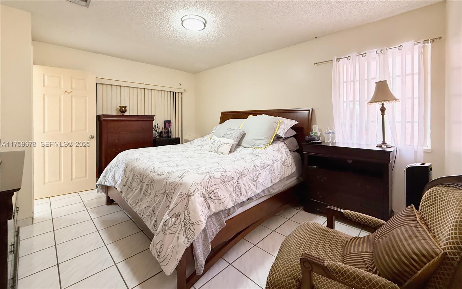 20520 Southwest 124th Place Miami, FL 33177 - Photo 7 of 34 a bed room with a bed and a couch