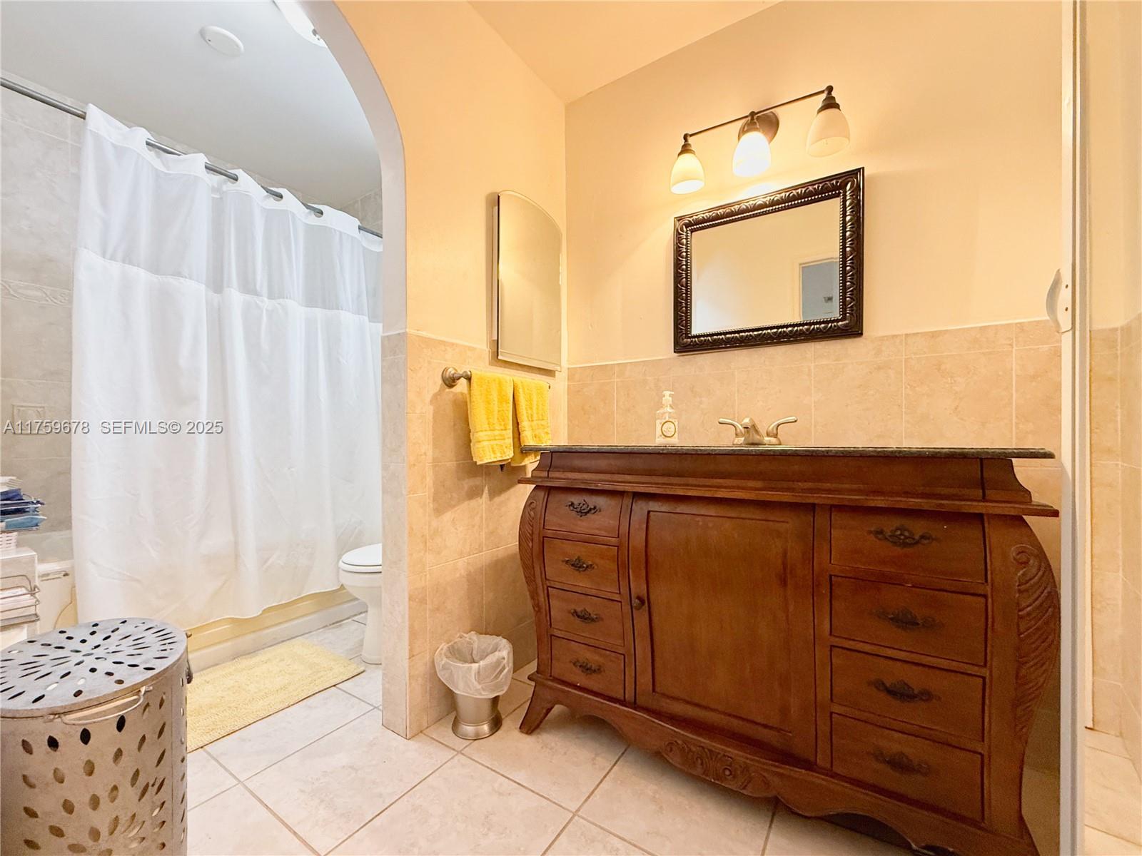20520 Southwest 124th Place Miami, FL 33177 - Photo 9 of 34 a bathroom with a granite countertop sink and a mirror