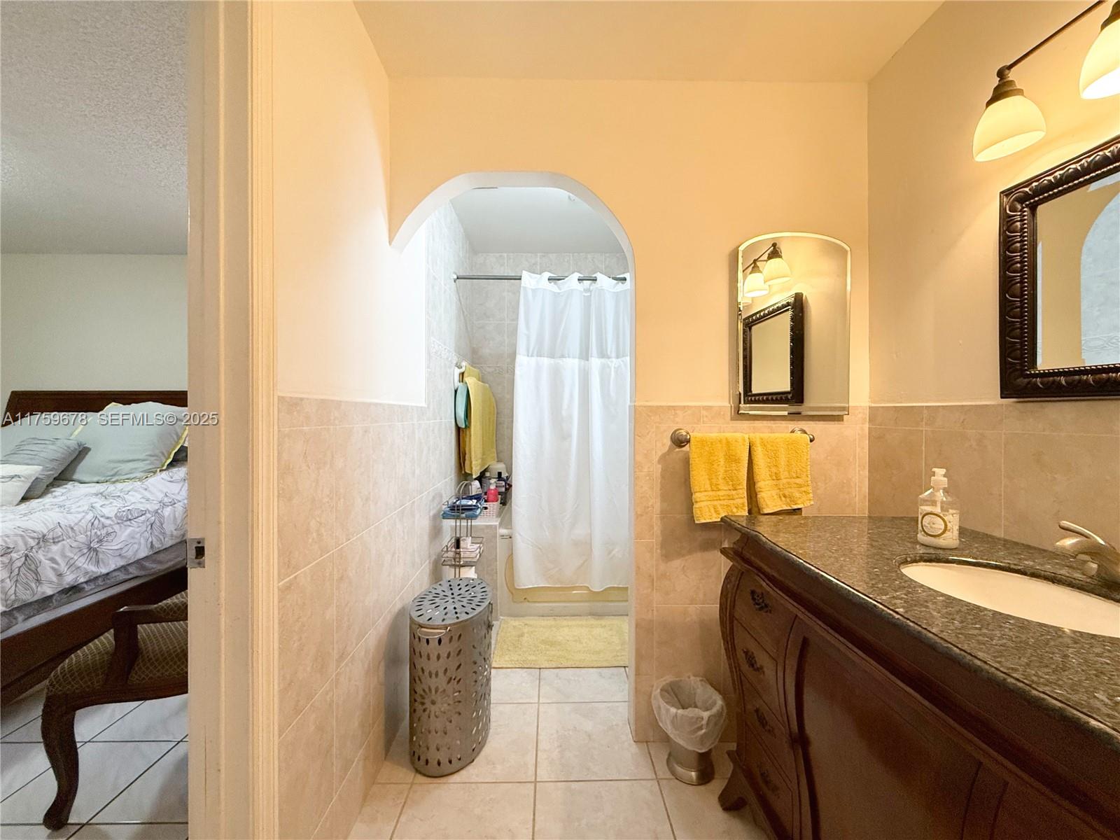 20520 Southwest 124th Place Miami, FL 33177 - Photo 10 of 34 a bathroom with a granite countertop sink a mirror and vanity