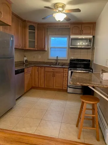 a kitchen with a stove a sink and cabinets