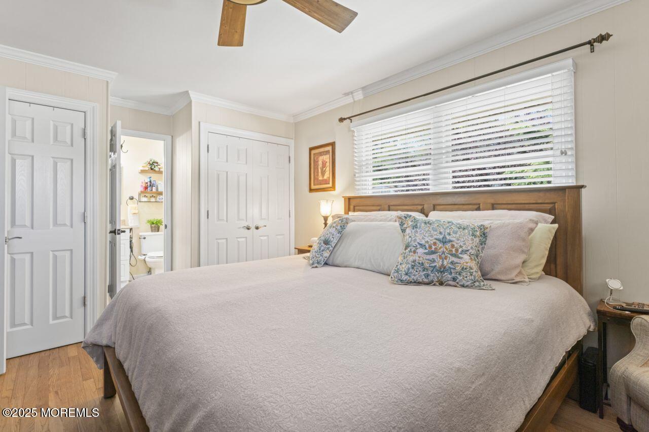 31 Cedar Avenue South Amboy, NJ 08879 - Photo 12 of 41 a large bed sitting in a bedroom next to a window and a chandelier