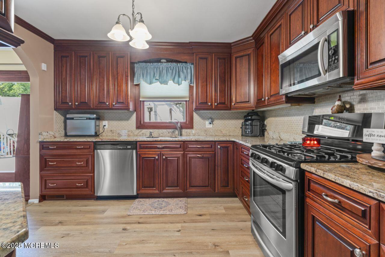 31 Cedar Avenue South Amboy, NJ 08879 - Photo 8 of 41 a kitchen with granite countertop wooden cabinets and stainless steel appliances