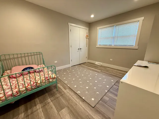 a bedroom with bed and window