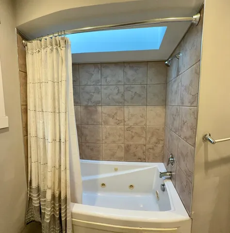 a bathroom with a bathtub and shower