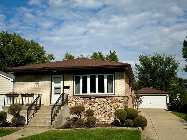a view of house with yard and sitting area