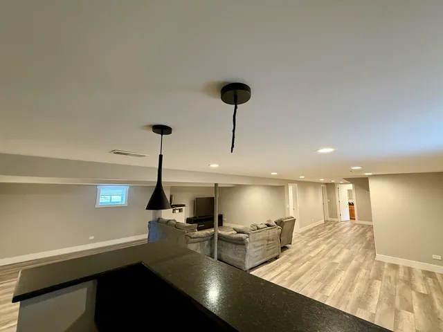 a living room with lots of furniture and a large window