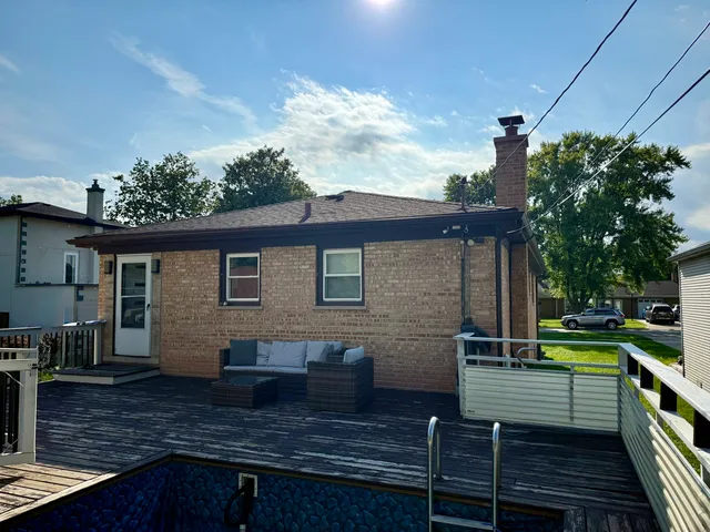 a view of a house with backyard and sitting area