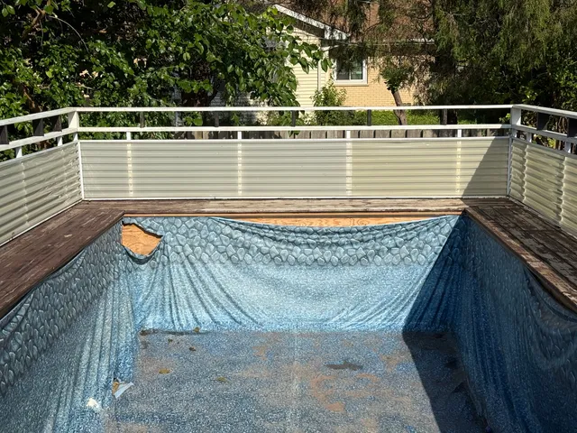 a view of a balcony with wooden floor and fence