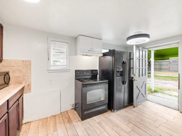 a kitchen with a sink stove and cabinets