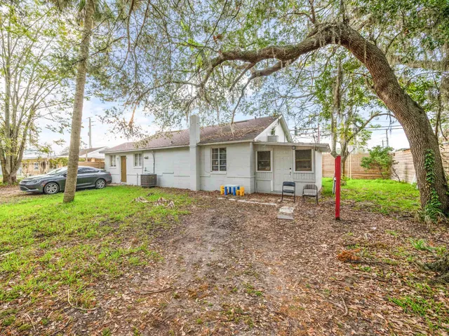 a living room with furniture a rug and white walls