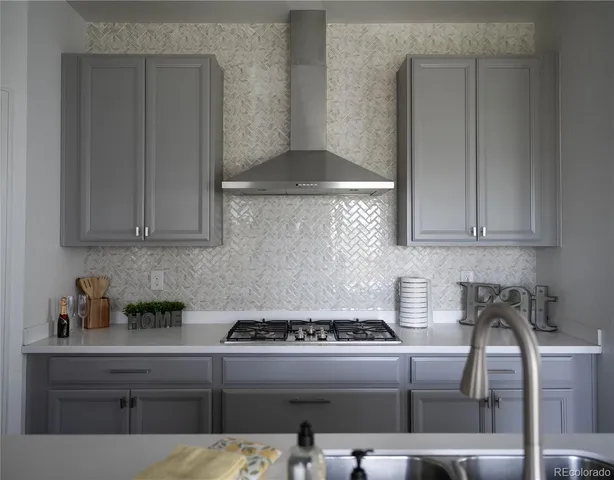 a kitchen with a sink and a stove