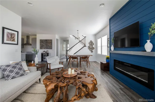 a living room with a fireplace and a potted plant