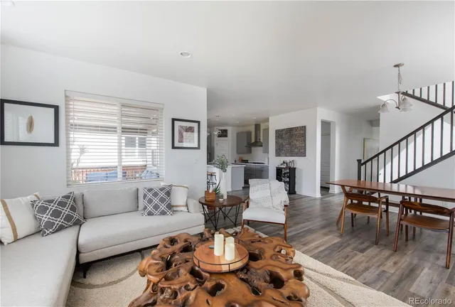 a living room with fireplace furniture and a wooden floor