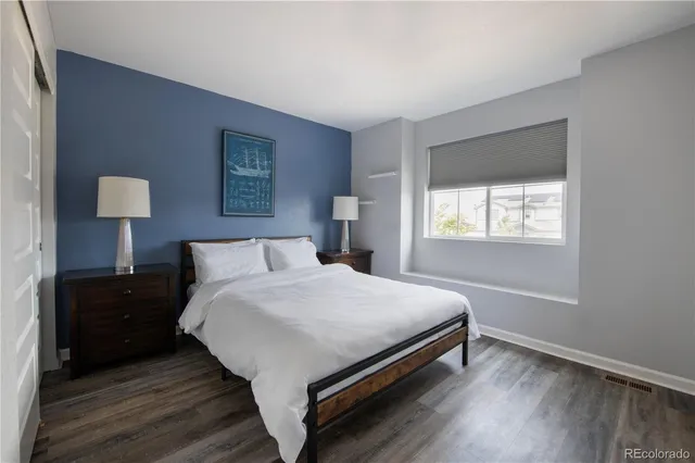 a bedroom with a bed and a lamp