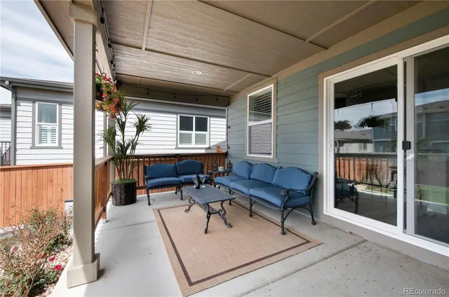 a balcony with furniture and book shelf
