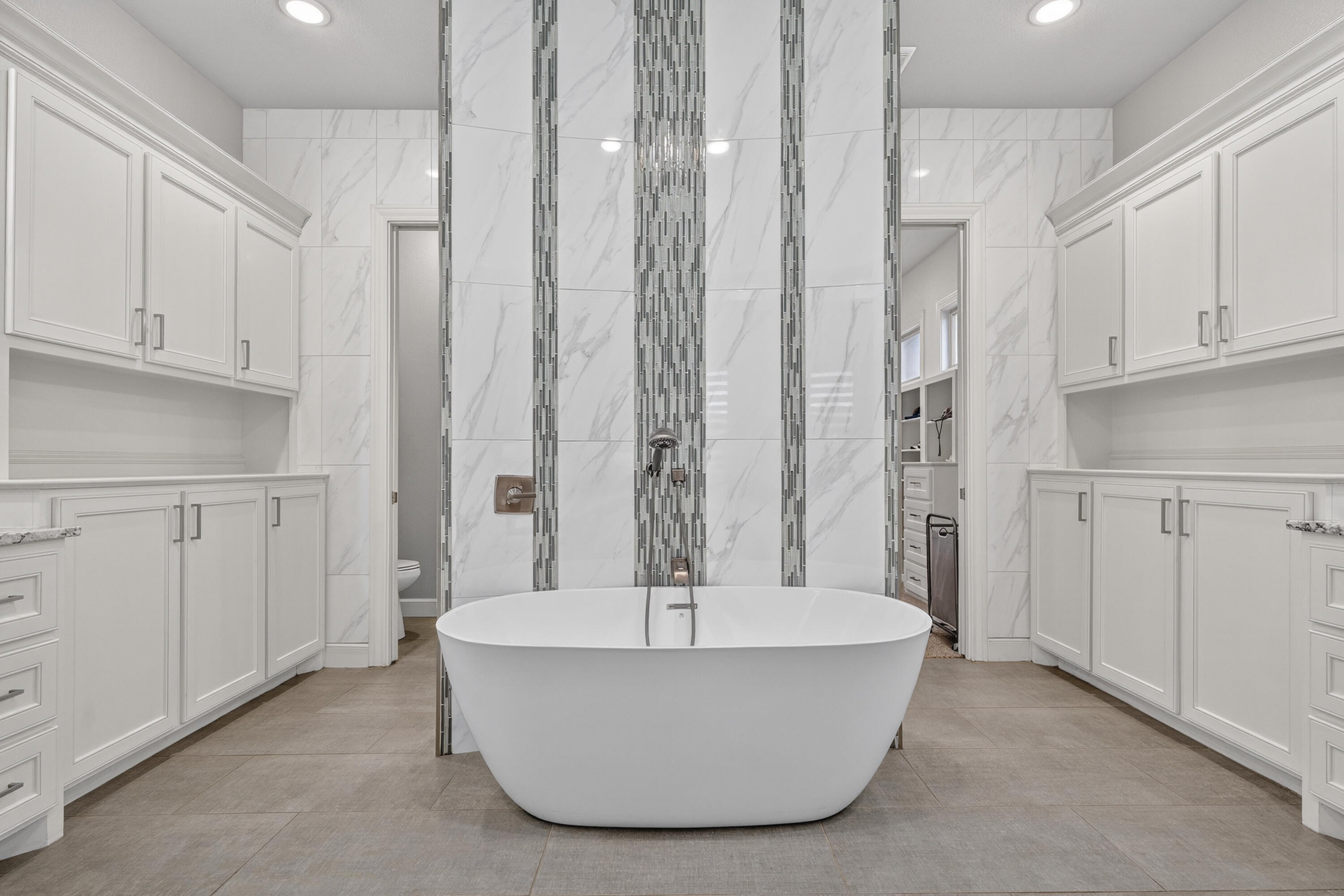 4003 140th Street Lubbock, TX 79423 - Photo 19 of 50 a white bath tub sitting in a en suite bathroom