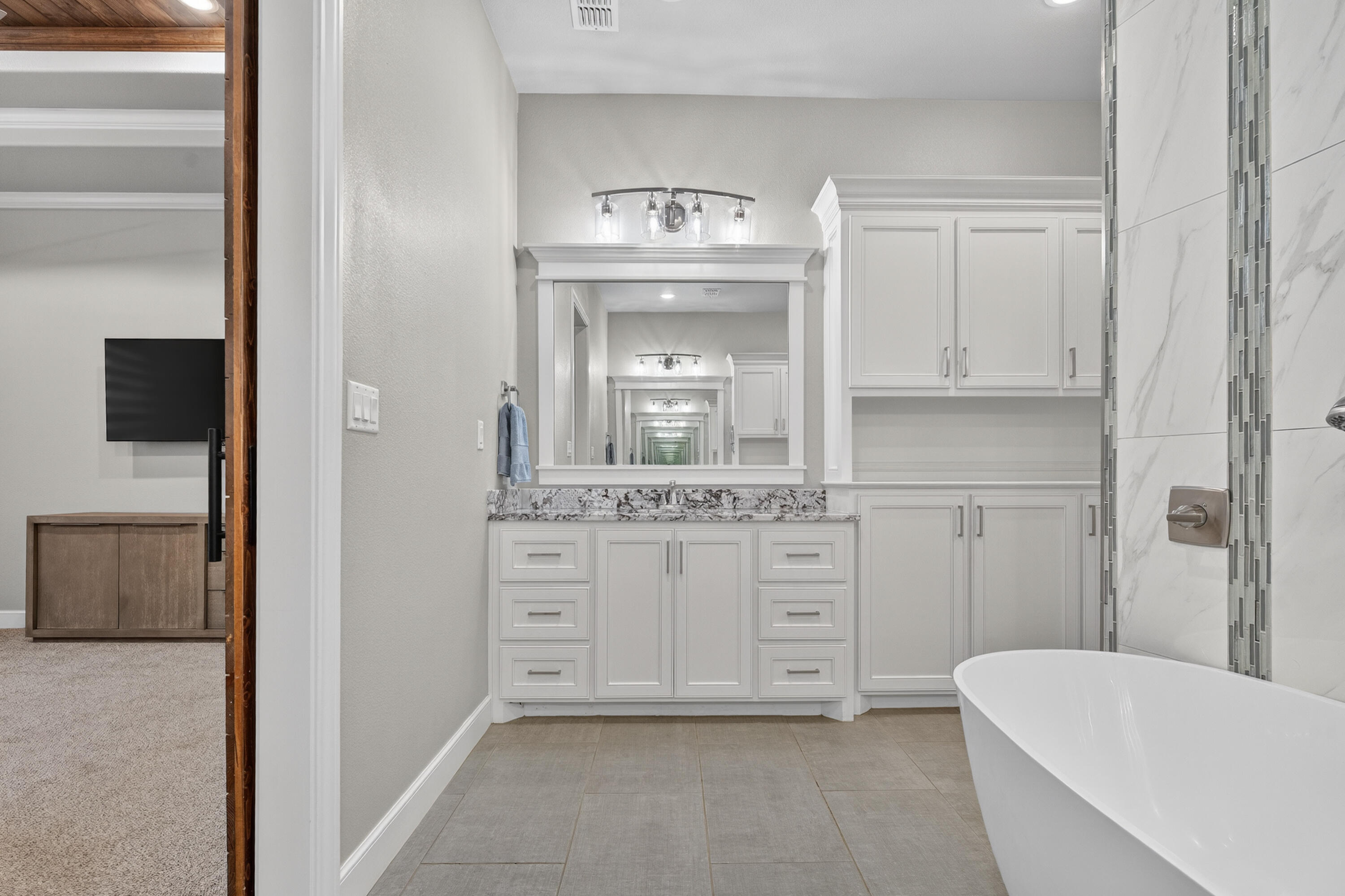 4003 140th Street Lubbock, TX 79423 - Photo 21 of 50 a bathroom with a sink a vanity and a mirror