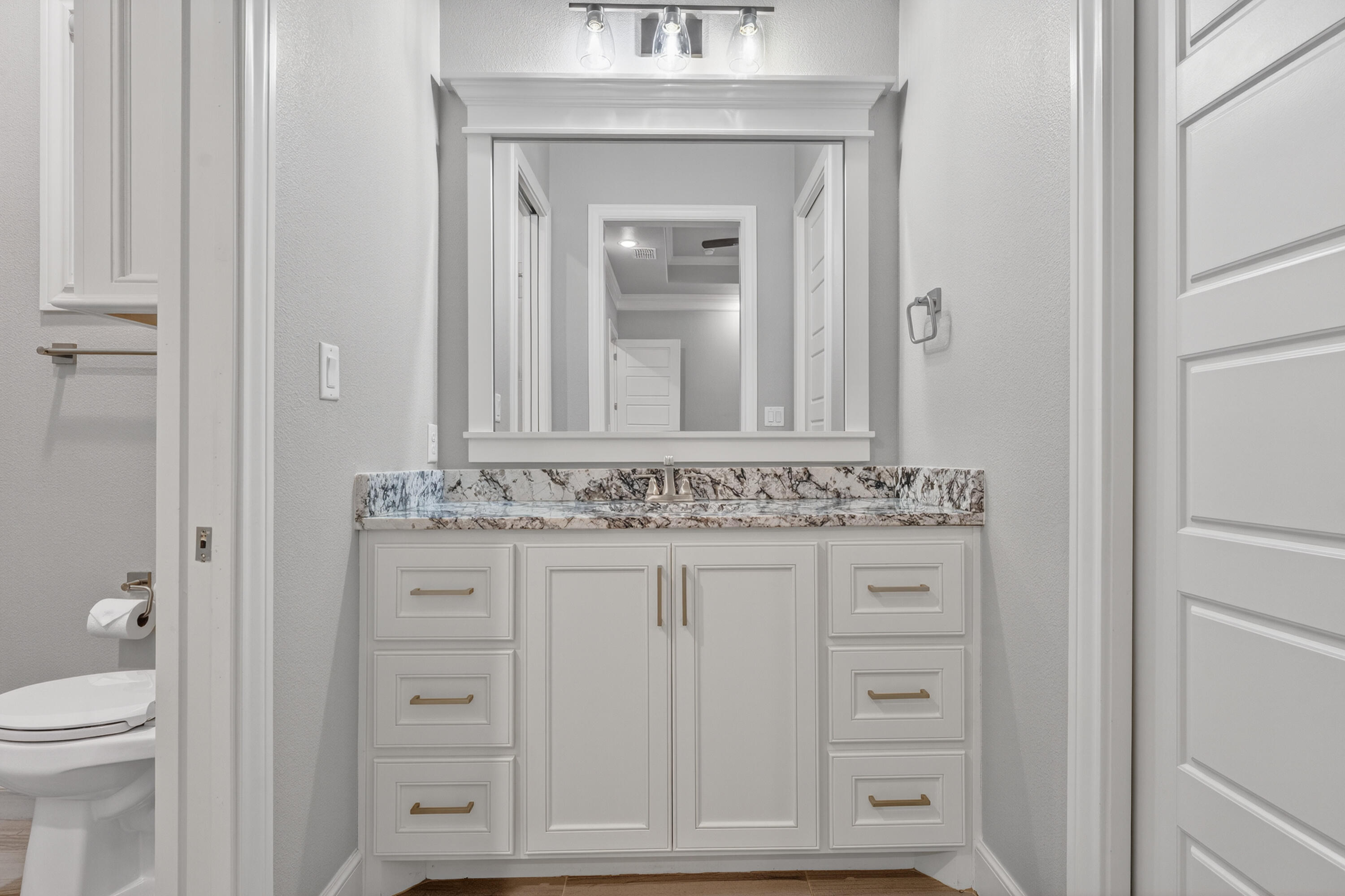 4003 140th Street Lubbock, TX 79423 - Photo 28 of 50 a bathroom with a sink vanity and toilet