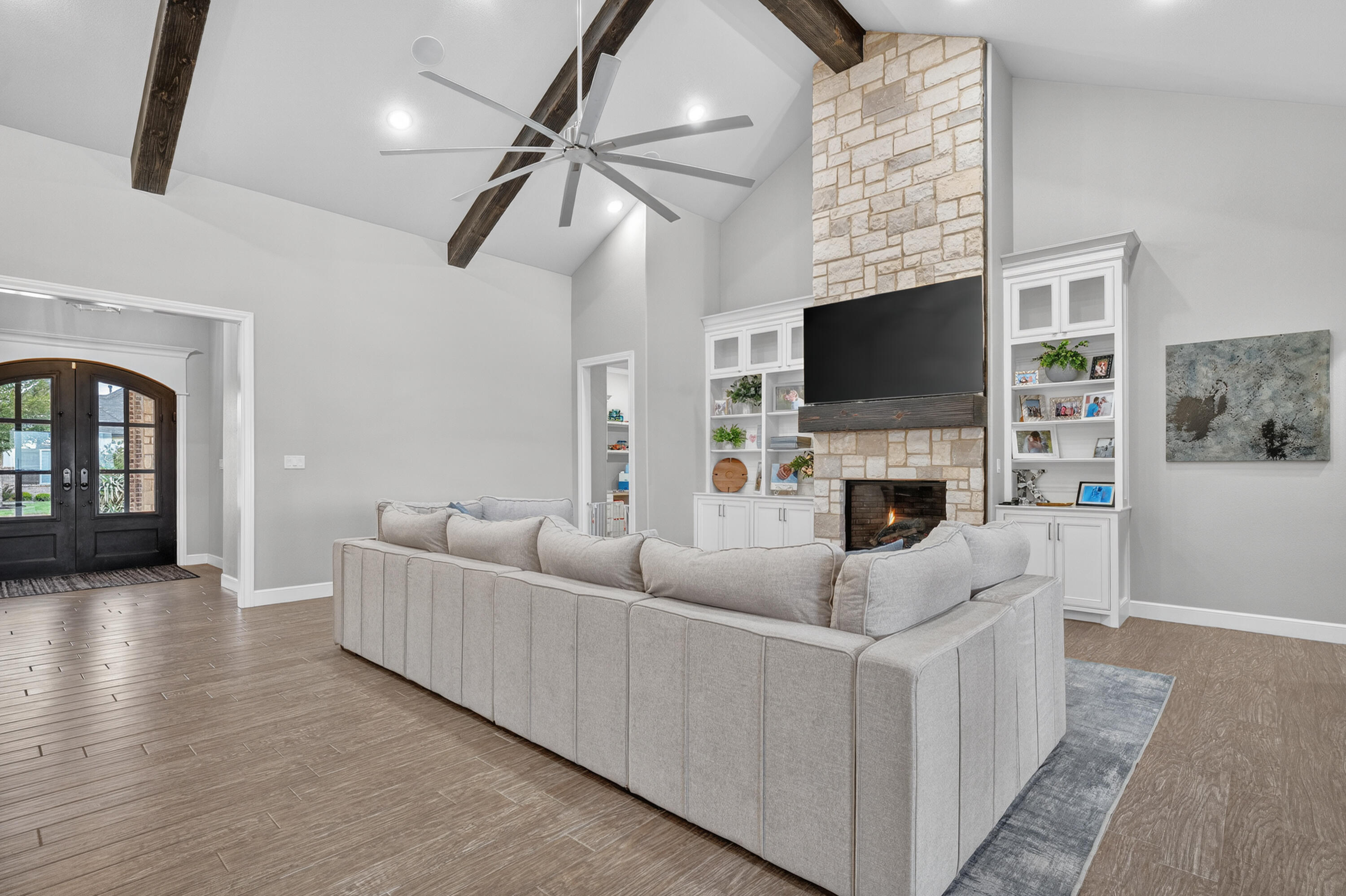 4003 140th Street Lubbock, TX 79423 - Photo 5 of 50 a living room with furniture a fireplace and a flat screen tv