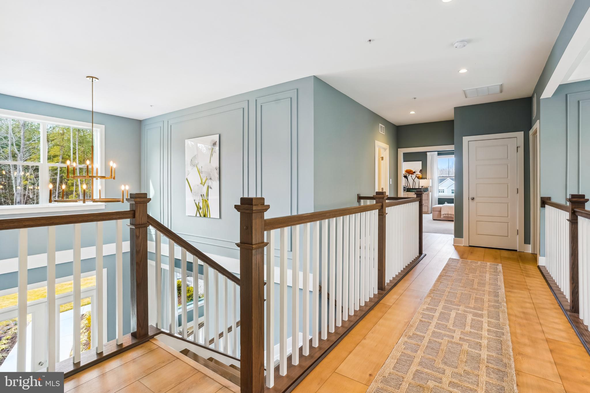 4996 Ilchester Road Ellicott City, MD 21043 - Photo 41 of 74 a view of a hallway with wooden floor and staircase