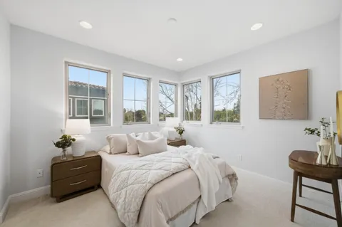 a bedroom with a bed and windows