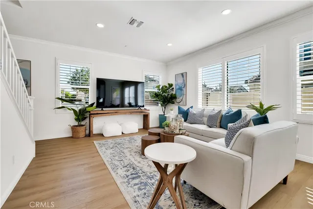 a living room with furniture rug and wooden floor