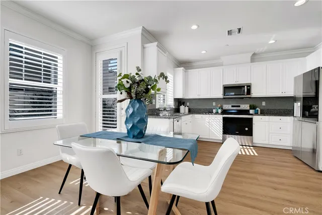 a kitchen with granite countertop white cabinets and white appliances