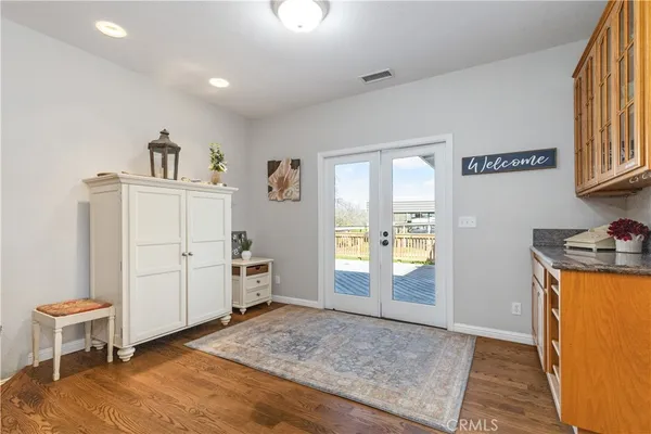 a bathroom with a granite countertop sink vanity and mirror