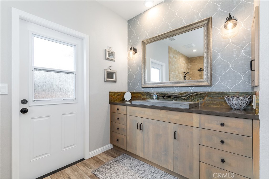 4375 Rustic Way San Luis Obispo, CA 93401 - Photo 36 of 65 a bathroom with a granite countertop sink vanity and mirror