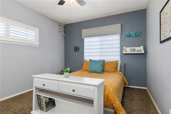a living room with furniture and a ceiling fan