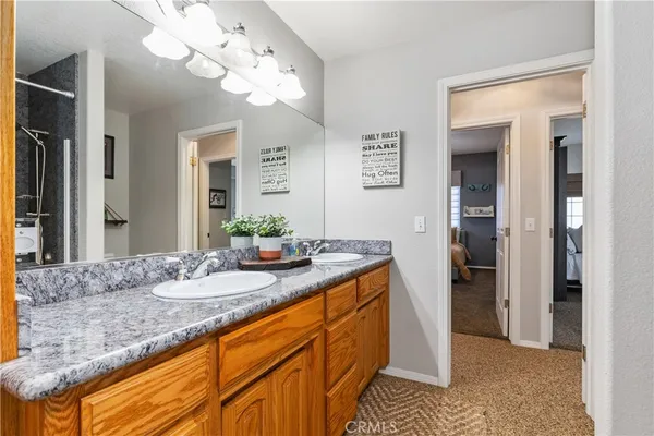 a bathroom with a sink mirror toilet and shower